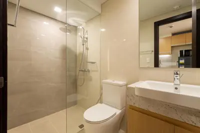 a bathroom with a toilet and a sink and a shower at Luxury 1 BR City View in Park Mckinley West Fast Wi-Fi Washer Dryer in Manila