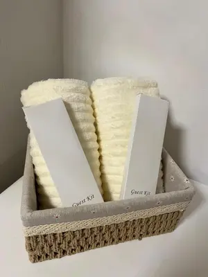 two towels in a basket on a table at CozyCorner By R&K in Manila