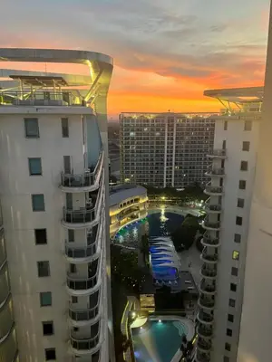 a view of a pool between two buildings at CozyCorner By R&K in Manila