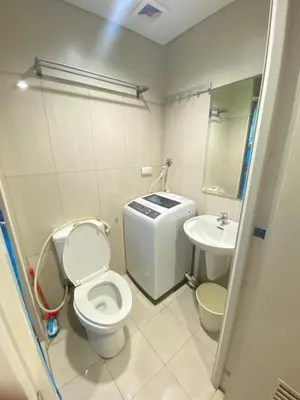 a bathroom with a toilet and a sink at Budget Condo in Mall Of Asia in Manila