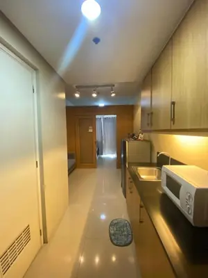 a small kitchen with a sink and a microwave at Budget Condo in Mall Of Asia in Manila