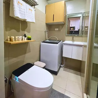 a small bathroom with a toilet and a sink at Shore 2 Residences Entire Condo in Pasay City Near SM Mall of Asia in Manila