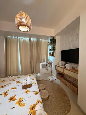 a bedroom with a bed with flowers on it at SYM staycation at Azure in Manila