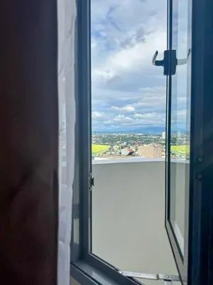 an open window with a view of a city at Staycation in Manhattan near Smart Araneta in Manila