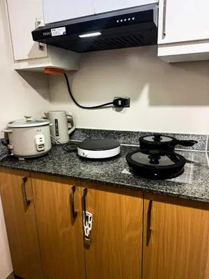 a kitchen with a counter top with a stove at Staycation in Manhattan near Smart Araneta in Manila