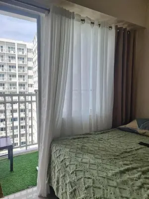 a bedroom with a bed and a large window at 1586 Shore Residences tower C2 in Manila