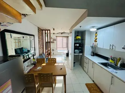 a kitchen with a table and a dining room at Ports crib in Manila