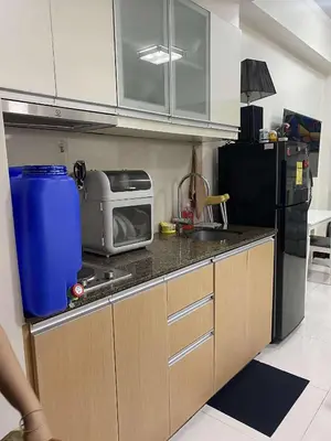 a small kitchen with a sink and a microwave at Vienna Condotel at 101 Newport Blvd in Manila