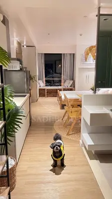 a dog is standing in the middle of a living room at Cozy Stay 3 min to Rockwell City View Pool Parking in Manila
