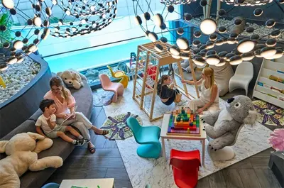 a group of children sitting in a room with stuffed animals at Cozy Stay 3 min to Rockwell City View Pool Parking in Manila