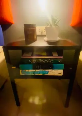 a small table with books and a plant on it at Azure Haven in Manila
