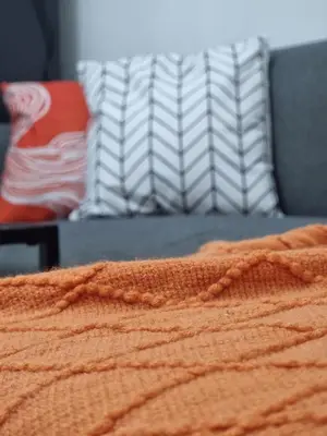 a close up of an orange blanket on a bed at MP shore 1 c2 unit1583 in Manila
