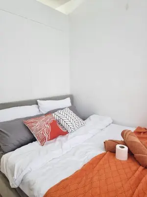 a white bed with pillows on top of it at MP shore 1 c2 unit1583 in Manila