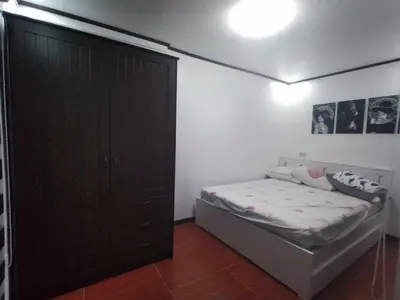 a bedroom with a bed and a black cabinet at Affordable 2-Storys Whole house in Imus in Imus
