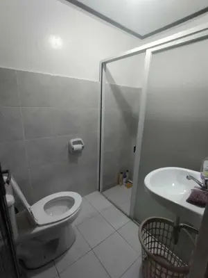 a bathroom with a shower and a toilet and a sink at Affordable 2-Storys Whole house in Imus in Imus