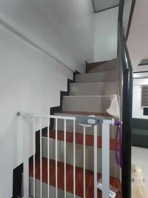 a staircase in a room with a stair railing at Affordable 2-Storys Whole house in Imus in Imus