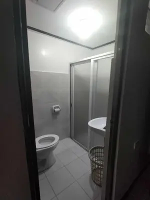 a bathroom with a shower and a toilet and a sink at Affordable 2-Storys Whole house in Imus in Imus