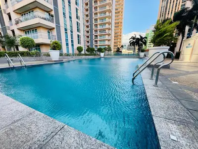 a swimming pool in the middle of a building at Cozy unit with balcony Netflix walk to Venice Mall in Manila