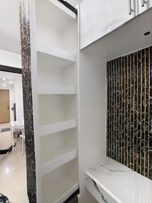 a white walk in closet with white shelves at La Casa Victoria-Near Moa and NAIA in Manila
