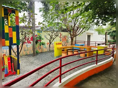 a playground with colorful benches and a fence at Paseo Verde Condo Unit in Las Pinas - Sleeps 2 Adults & 2 Children in Manila