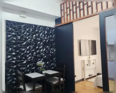 a dining room with a black and white wall at Paseo Verde Condo Unit in Las Pinas - Sleeps 2 Adults & 2 Children in Manila