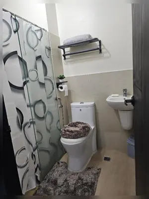 a bathroom with a toilet and a shower at Paseo Verde Condo Unit in Las Pinas - Sleeps 2 Adults & 2 Children in Manila