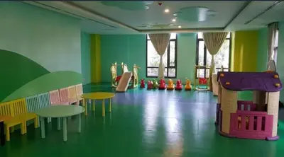 a childrens play room with tables and a slide at Cozy Studio Viceroy Residences in Manila