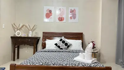 a bedroom with a bed with black and white pillows at One Palm Tree Villas at Newport, Near NAIA T3 in Manila