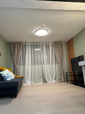 a living room with a couch and a large window at Jopays 2BR, Brand New Unit in Cainta
