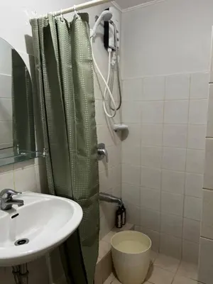a bathroom with a sink and a shower at Cozy 2BR at an Italian inspired condo near Ortigas in Manila