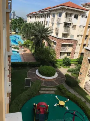 a view of a swimming pool from a building at Cozy 2BR at an Italian inspired condo near Ortigas in Manila