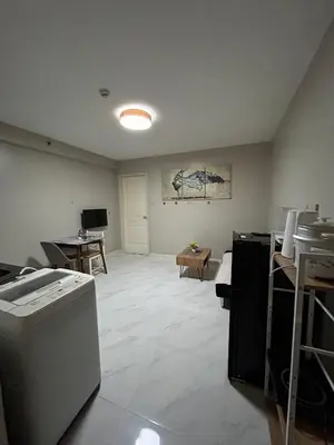 an empty room with a kitchen and a living room at Condo near MOA Monarch in Manila
