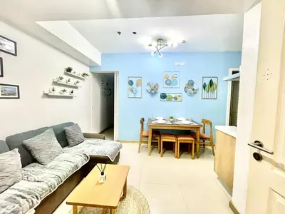 a living room with a couch and a table at AzurestaycationbyGS in Manila