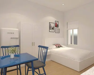 a bedroom with a bed and a blue table and chair at Llanes A Studio Apartment in Manila