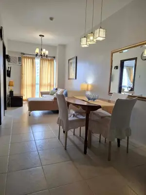 a living room with a table and a couch at Cozy Hotel-Style 1 Bedroom Unit 5L at Eastbay Residences by Rockwell in Manila