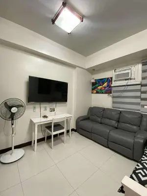 a living room with a couch and a table at Vienna Condotel in Manila