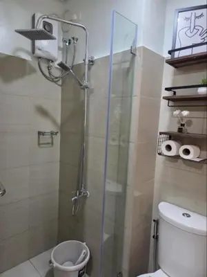 a shower with a glass door in a bathroom at Shore 2 Residences in Manila