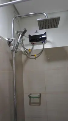 a shower in a bathroom with a hair dryer at Shore 2 Residences in Manila