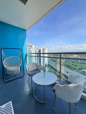 a balcony with a table and chairs and a view at The Session Azure in Manila