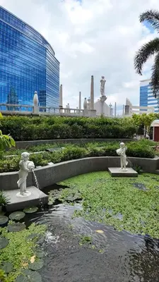 two statues in a pond in front of a building at Venice Luxe Cozy 1 BedRoom, Pool, Netflix, Kitchen, Canal Mall Access in Manila