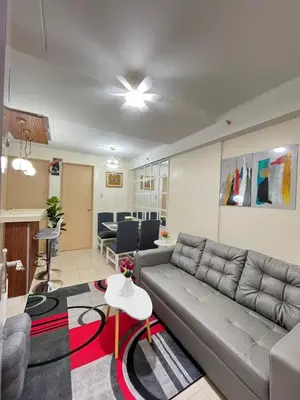 a living room with a couch and a table at 2BR DECA HOME Pasig City in Manila