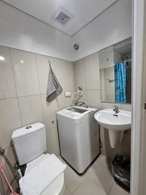 a bathroom with a toilet and a sink at Shell Low Floor Amenity Pool View with Balcony MOA Shell004 in Manila