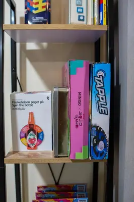 a group of books on a book shelf at Cozy 1BR Balcony with Pool View Plus Free Parking in Manila