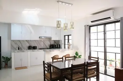 a kitchen and dining room with a table and chairs at Idesia Dasmarinas NEW 3BR home with wifi & parking in Dasmariñas