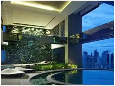 a building with a pool with a view of a city at STAYLUXIA BOUTIQUE HOTEL GRAMERCY Balcony FREE Pool, Gym, Netflix in Manila
