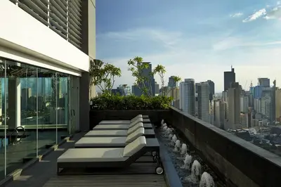 a balcony of a building with a view of the city at STAYLUXIA BOUTIQUE HOTEL GRAMERCY Balcony FREE Pool, Gym, Netflix in Manila