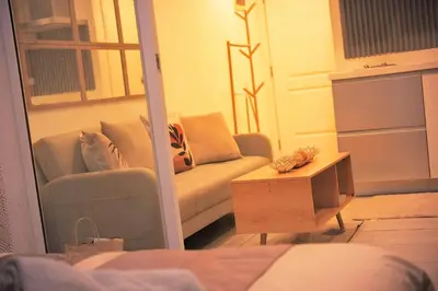 a living room with a couch and a table at Cozy Tahanan Azure Studio close to NAIA in Manila