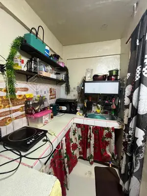 a kitchen with a counter with a sink and a stove at Liza homestay in Manila