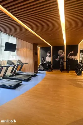 a room with a gym with pilates equipment on the wall at Modern Condo at Park McKinley West with Wi-Fi and Washer in Manila