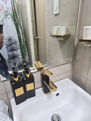 a bathroom with a white sink and a mirror at Zen 2 Shore A Residences in Manila